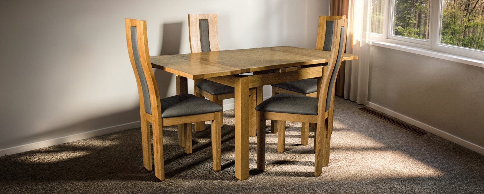 Oak extending dining table with four high-back upholstered chairs from Mainland Furniture